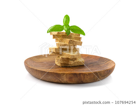 Tofu Cheese Isolated, Smoked Vegan Cheese Slice, Sliced Soya Bean Curd, Soy Protein or TSP Tofu Cheese Isolated, Smoked Vegan Cheese Slice, Sliced Soya Bean Curd, Soy Protein or TSP 107694254