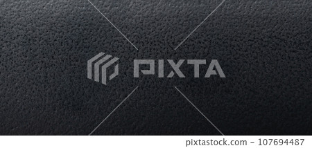 Rough black plastic texture background 107694487