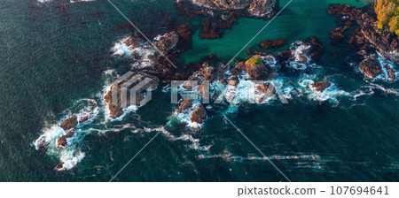 Rocky Shore on the Pacific Ocean Coast in Tofino, Vancouver Island, BC, Canada. Sunset. Aerial 107694641