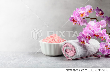 Beautiful blooming orchid flowers and pink sea salt. Beautiful blooming orchid flowers and pink sea salt. 107694816