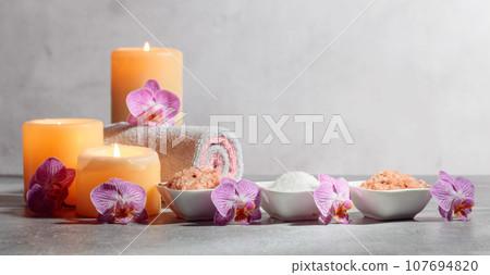 Sea salt, towels, orchid flowers, and burning candles. Sea salt, towels, orchid flowers, and burning candles. 107694820