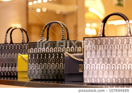 Fashionable women's handbags on mall window. Sale Fashionable women's handbags on mall window. Sale 107694899