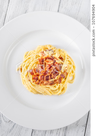 Portion of carbonara pasta Portion of carbonara pasta 107694904
