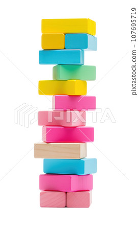 Colorful blocks stacked high in a tower, ready to topple isolated Colorful blocks stacked high in a tower, ready to topple isolated 107695719