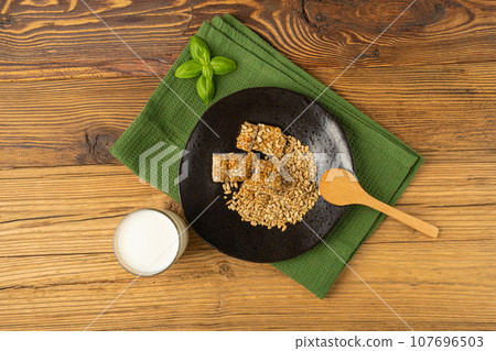Sunflower Seeds Bar on Black Plate, Energy Snack with Honey, Sun Flower Seed Muesli Dessert Sunflower Seeds Bar on Black Plate, Energy Snack with Honey, Sun Flower Seed Muesli Dessert 107696503