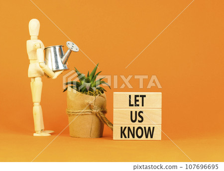 Let us know symbol. Concept words Let us know on wooden blocks on a beautiful orange table orange background. Businessman model. Business and let us know concept. Copy space. Let us know symbol. Concept words Let us know on wooden blocks on a beautiful orange table orange background. Businessman model. Business and let us know concept. Copy space. 107696695