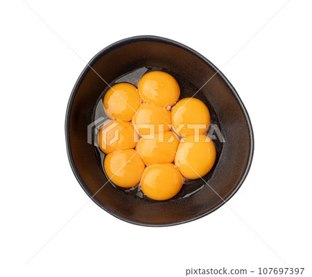 Egg Yolks in Bowl, Fresh Chicken Egg Yolk Separated from Whites for Cooking Recipe, Organic Yolks Top View 107697397