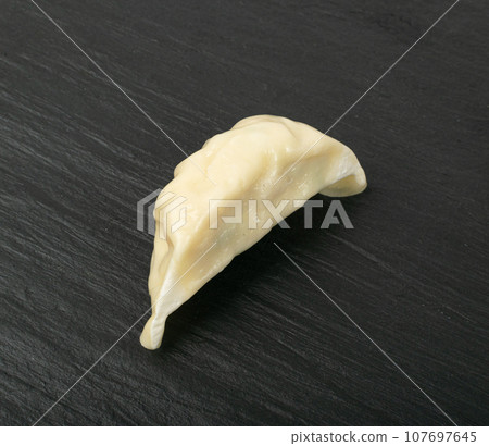 Single Gyoza Chinese Dumpling, Steamed Vegetable Jiaozi, Chicken Momo, One Asian Gyoza on Black 107697645