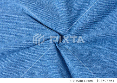 Blue denim, fabric twisted, close up 107697763