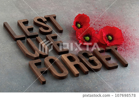World War remembrance day. Red poppies on dark stone background. Lest we forget 107698578