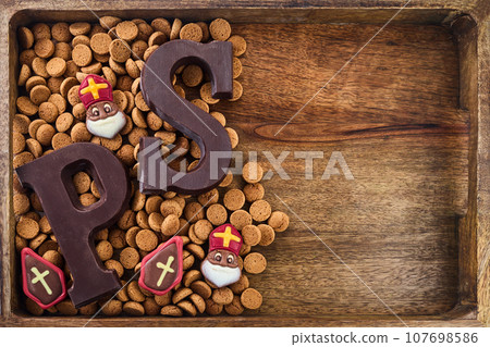Dutch holiday Sinterklaas background with traditional sweets and chocolate letter. 107698586