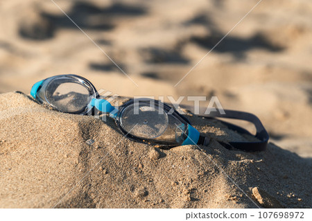 Sun glasses on a tropical beach sand, summer holiday Sun glasses on a tropical beach sand, summer holiday 107698972