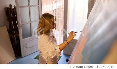 Fine art teacher or student drawing on canvas in creative workshop or art gallery. People. Hobby. Creative occupation 107699049