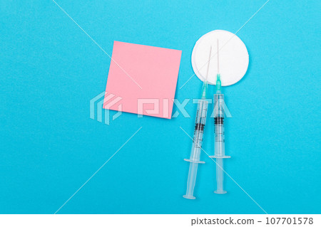 Vaccination or Revaccination Concept - Two Medical Syringe on Blue Table 107701578