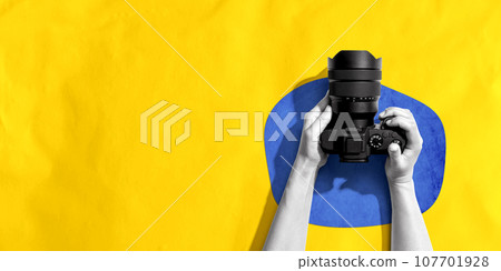 Person holding a SLR camera 107701928