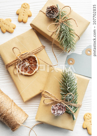 Christmas gifts, gingerbread cookies, decorations with christmas tree. Christmas gifts, gingerbread cookies, decorations with christmas tree. 107702835