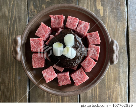 Beef hot pot with chunks of Wagyu beef in a miso broth, a Japanese-style sukiyaki hot pot. Beef hot pot with chunks of Wagyu beef in a miso broth, a Japanese-style sukiyaki hot pot. 107702859