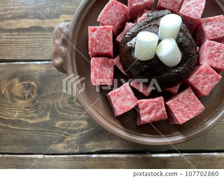 Beef hot pot with chunks of Wagyu beef in a miso broth, a Japanese-style sukiyaki hot pot. Beef hot pot with chunks of Wagyu beef in a miso broth, a Japanese-style sukiyaki hot pot. 107702860