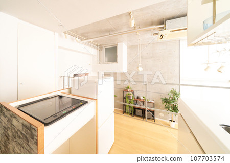Interior image of a stylish kitchen with an IH stove and refrigerator 107703574