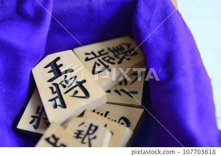 Shogi pieces wrapped in purple cloth Shogi pieces wrapped in purple cloth 107703618