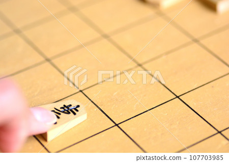 Finger pointing at shogi on the shogi board Finger pointing at shogi on the shogi board 107703985