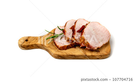 Baked Pork Slices on Wooden Cutting Board. Roasted Sliced Loin, Tenderloin Ham Piece Baked Pork Slices on Wooden Cutting Board. Roasted Sliced Loin, Tenderloin Ham Piece 107704716