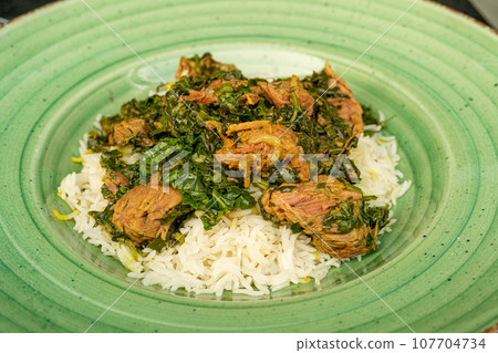 Pilau on Green Plate, Beef Pilaf, Traditional Asian Dish Plov also known as Polow, Pilav, Pallao, Pulao, Palaw Pilau on Green Plate, Beef Pilaf, Traditional Asian Dish Plov also known as Polow, Pilav, Pallao, Pulao, Palaw 107704734