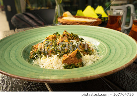 Pilau on Green Plate, Beef Pilaf, Traditional Asian Dish Plov also known as Polow, Pilav, Pallao, Pulao, Palaw 107704736