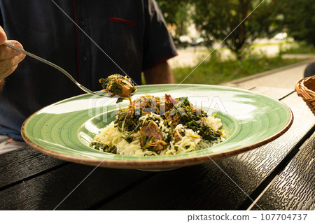 Pilau on Green Plate, Beef Pilaf, Traditional Asian Dish Plov also known as Polow, Pilav, Pallao, Pulao, Palaw Pilau on Green Plate, Beef Pilaf, Traditional Asian Dish Plov also known as Polow, Pilav, Pallao, Pulao, Palaw 107704737