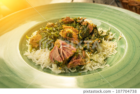 Pilau on Green Plate, Beef Pilaf, Traditional Asian Dish Plov also known as Polow, Pilav, Pallao, Pulao, Palaw 107704738