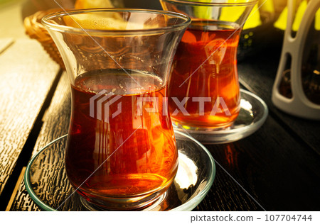 Turkish Tea on a Street Cafe Table, Arabic Cup in Restaurant, Black Tea Drinking in Turkish Cup 107704744