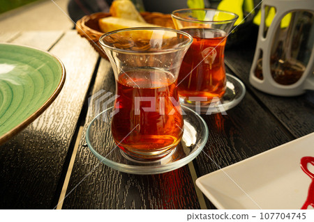 Turkish Tea on a Street Cafe Table, Arabic Cup in Restaurant, Black Tea Drinking in Turkish Cup 107704745