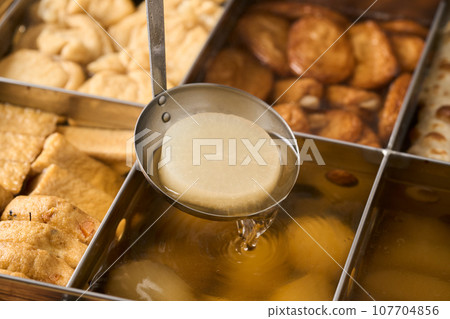 Hot oden - scoop daikon radish with a ladle Hot oden - scoop daikon radish with a ladle 107704856