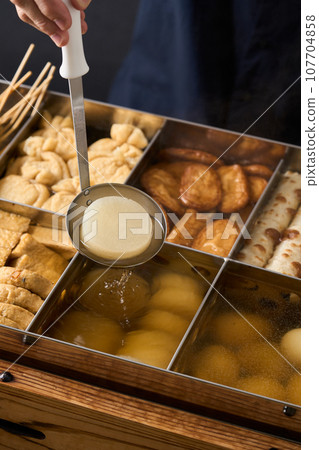Hot oden - scoop daikon radish with a ladle Hot oden - scoop daikon radish with a ladle 107704858
