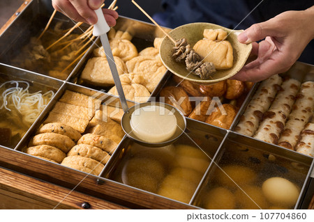 Hot oden - scoop daikon radish with a ladle 107704860