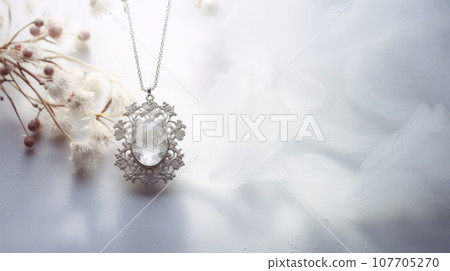 A silver pendant necklace with a clear stone and white flowers on a white background. This image is elegant and feminine, with a floral design and a shiny texture. The pendant is in the shape of a A silver pendant necklace with a clear stone and white flowers on a white background. This image is elegant and feminine, with a floral design and a shiny texture. The pendant is in the shape of a 107705270