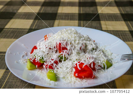 Traditional Bulgarian Shopska salad on a table Traditional Bulgarian Shopska salad on a table 107705412