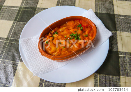 Tavche gravche (baked beans) - traditional Macedonian dish on a table Tavche gravche (baked beans) - traditional Macedonian dish on a table 107705414
