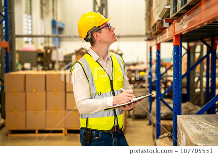 Warehouse workers talking together checking goods in storage 107705531