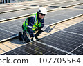 Engineers with safety helmet checking solar system at solar power farm 107705564