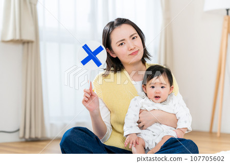 young mom with cross plate 107705602