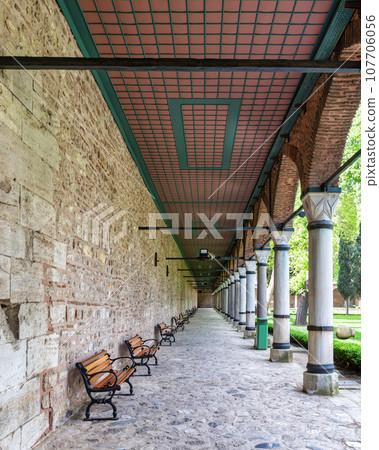 Long covered paved walkway with columns and benches, located in the courtyard of Topkapi Palace, Istanbul, Turkey Long covered paved walkway with columns and benches, located in the courtyard of Topkapi Palace, Istanbul, Turkey 107706056