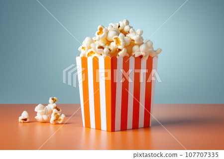 Delicious popcorn in a red striped paper cup Delicious popcorn in a red striped paper cup 107707335