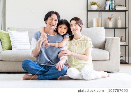 一個在客廳裡放鬆的年輕家庭 一個在客廳裡放鬆的年輕家庭 107707693