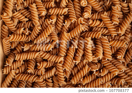 Raw Brown Pasta, Wholegrain Fusilli, Dry Whole Grain Noodle, Raw Spelt Macaroni, Healthy Italy Food 107708377