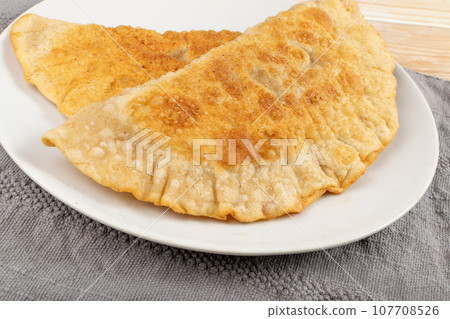 Deep-Fried Flat Pie. Turnover with Filling of Ground Meat and Onions, Stuffed Chebureki, 107708526