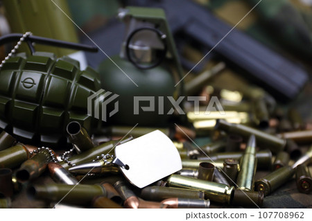 Different types of ammunition on a camouflage background. Preparing for war Different types of ammunition on a camouflage background. Preparing for war 107708962