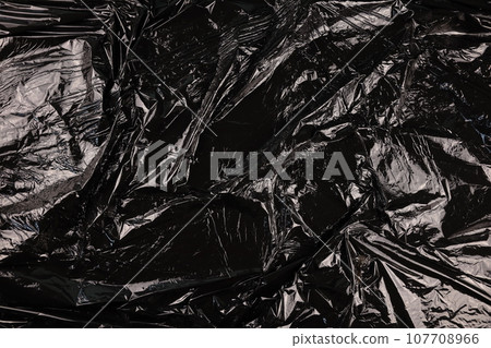 Texture of black plastic garbage disposable bag 107708966