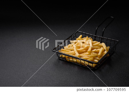 Fresh delicious crispy French fries with salt and spices 107709595