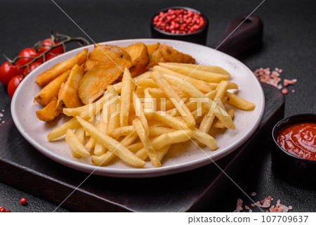 Fresh delicious crispy French fries with salt and spices Fresh delicious crispy French fries with salt and spices 107709637